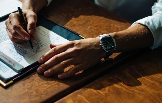 Man writing notes down for a perfect cover letter for his job search