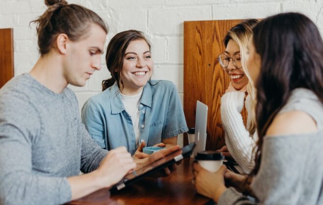 A diverse group of four people sitting together, learning how to use networking to their advantage